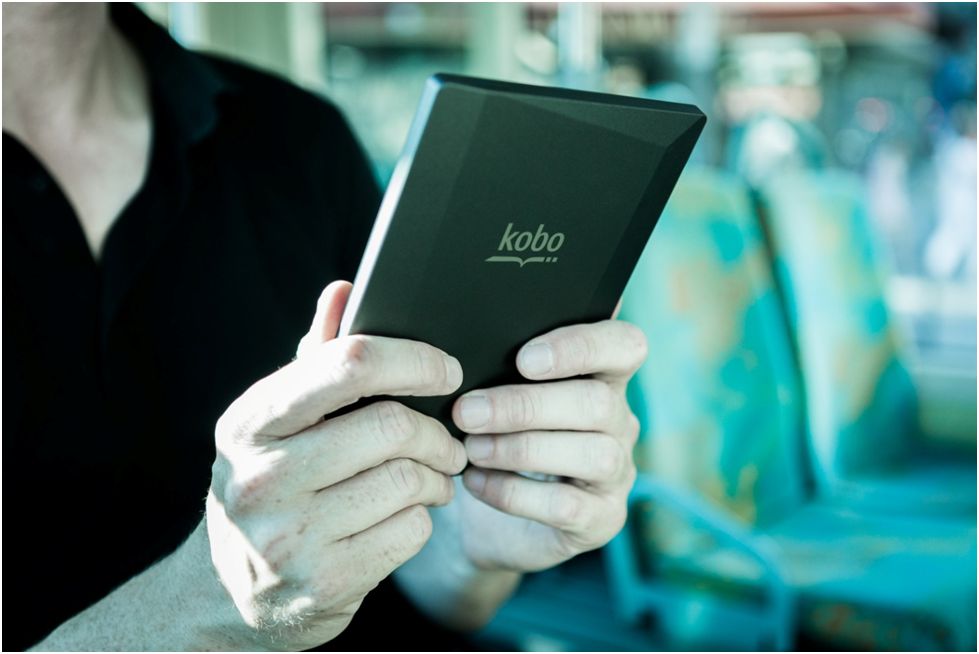 person holding an e-reader with both hands